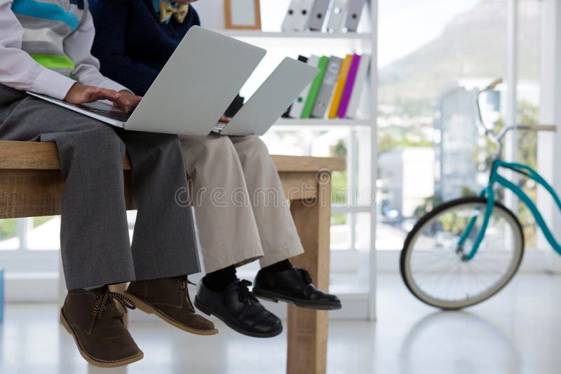 Kids as business executives using laptop in office stock photos Kids as business executives using laptop in office stock photos