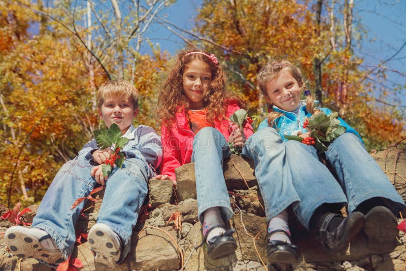 Kids in an autumn garden stock images