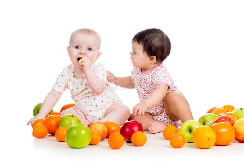 Funny kids babies eating healthy food fruits on white background