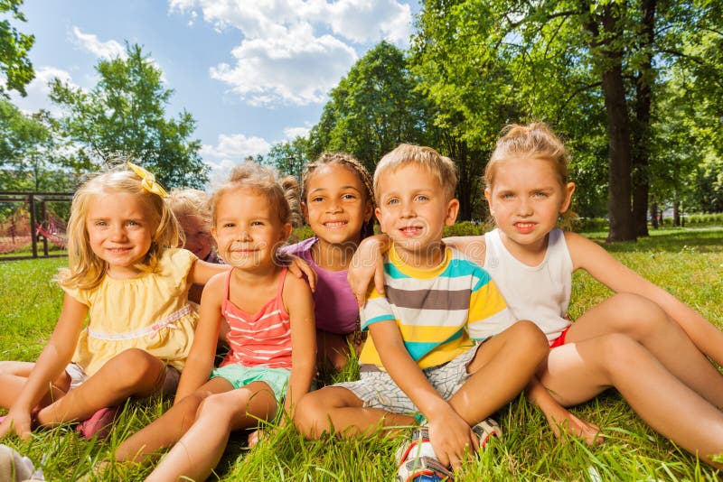 Kids, boys and girls on the lawn in park stock image Kids, boys and girls on the lawn in park stock image