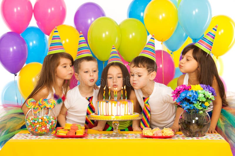 Kids celebrating birthday party and blowing