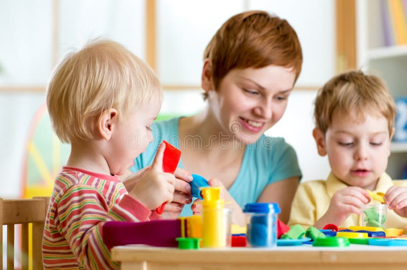 Kids or children and mother play colorful clay toy stock photo Kids or children and mother play colorful clay toy stock photo