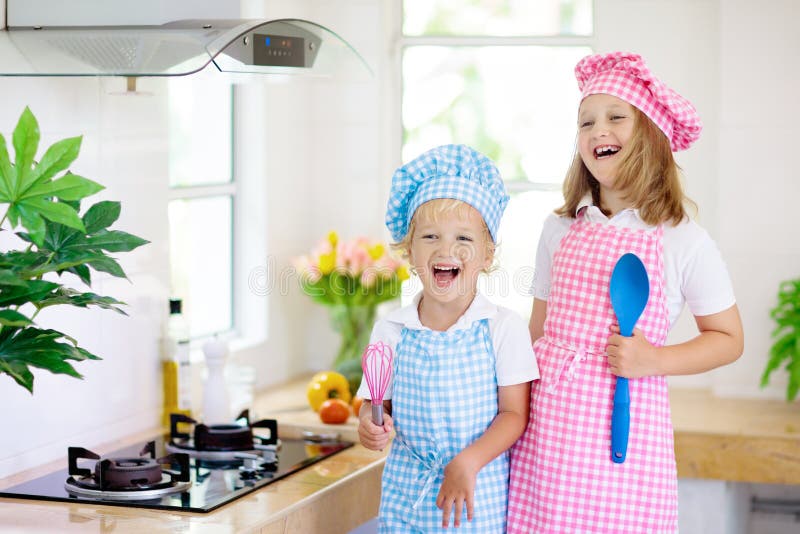 Kids cook in white kitchen. Children cooking