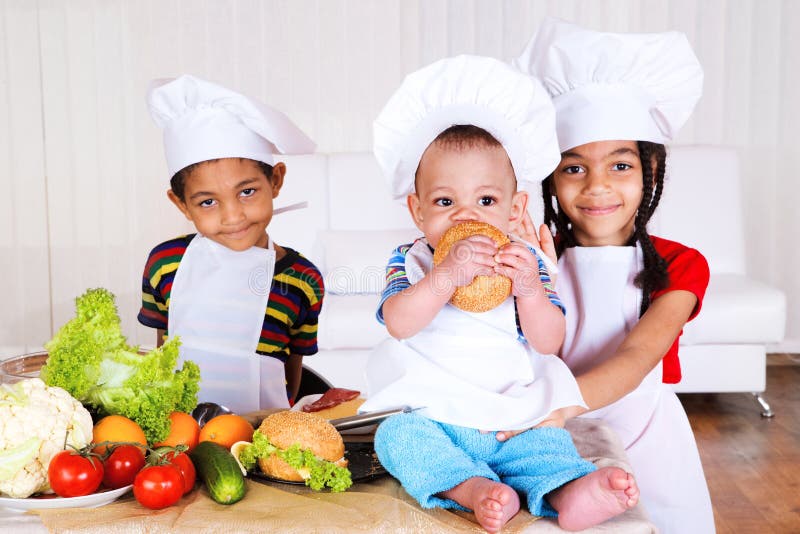 Three african american kids cooking