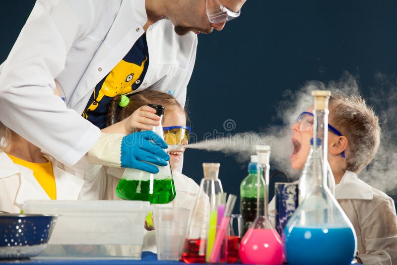 Kids with crazy professor doing science experiments in the laboratory