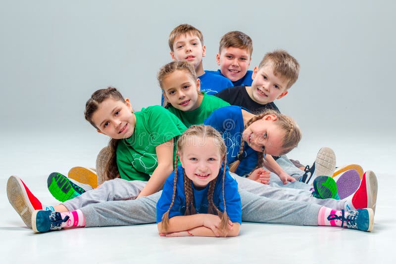 The kids dance school, ballet, hiphop, street, funky and modern dancers on gray studio background