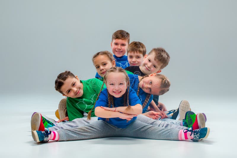 The kids dance school, ballet, hiphop, street, funky and modern dancers on gray studio background