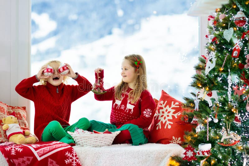 Kids decorate Christmas tree. Child on Xmas eve