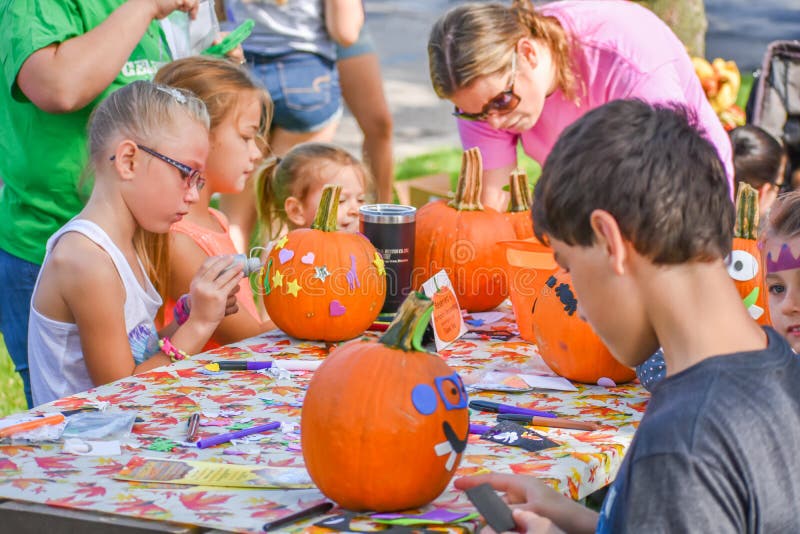 Kids Decorating Pumpkins at Festival