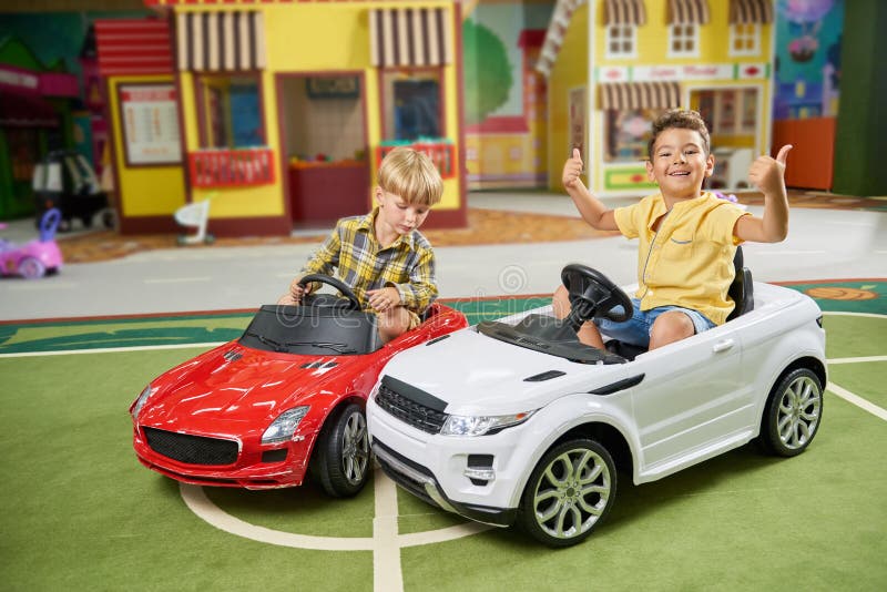 meesteres Bijwonen onderpand Kids Driving Big Electric Toy Cars in Playground. Stock Photo - Image of  indoor, happy: 172692186
