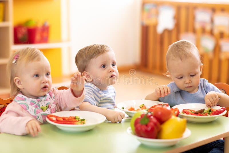 Kids eating in kindergarten or day care centre