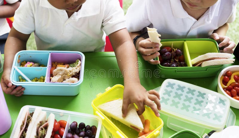 Kids eating lunch at elementary school stock photography