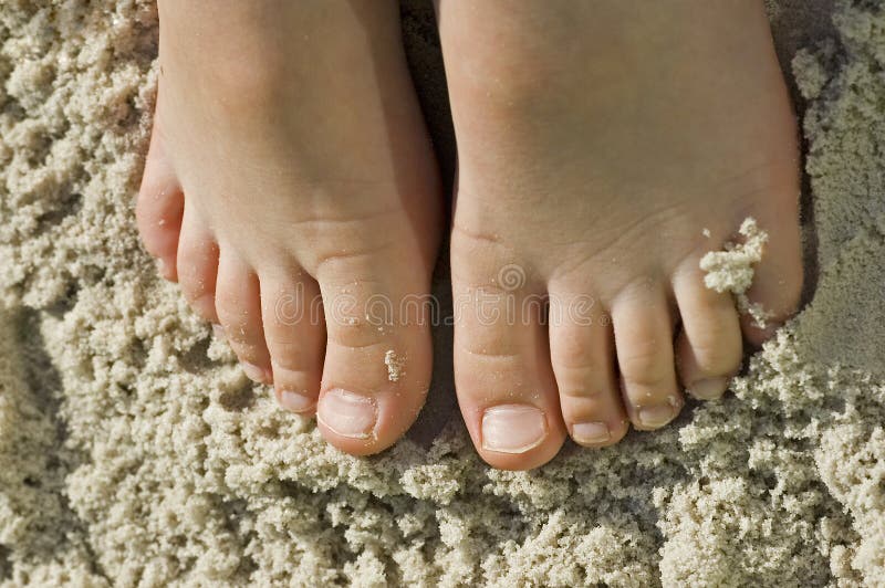 A child's feet in sandy beach. A child's feet in sandy beach