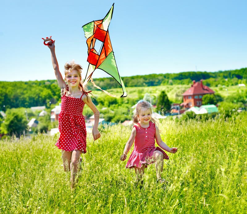 Kids flying kite outdoor.
