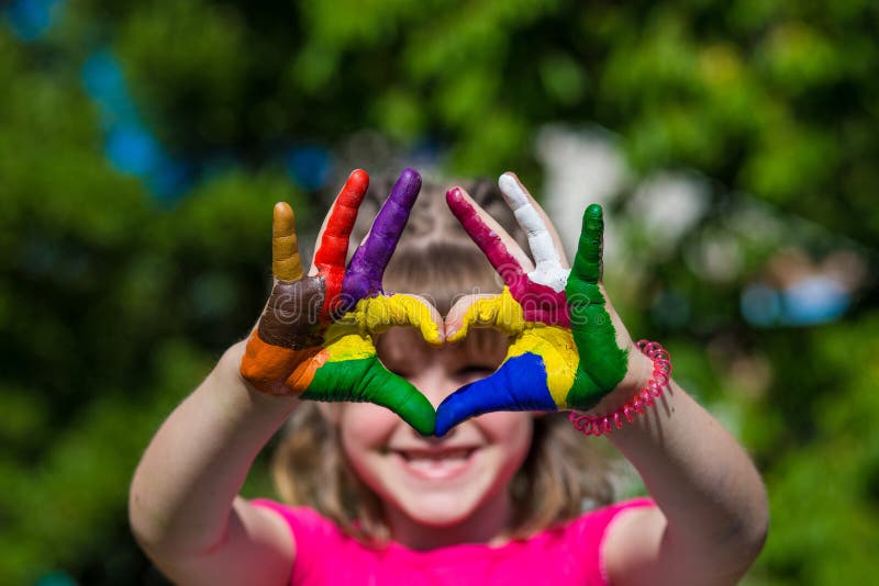 Kids hands in color paints make a heart shape, focus on hands stock image Kids hands in color paints make a heart shape, focus on hands stock image