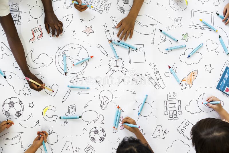Kids hands holding colored pencils painting on art drawing paper royalty free stock photos
