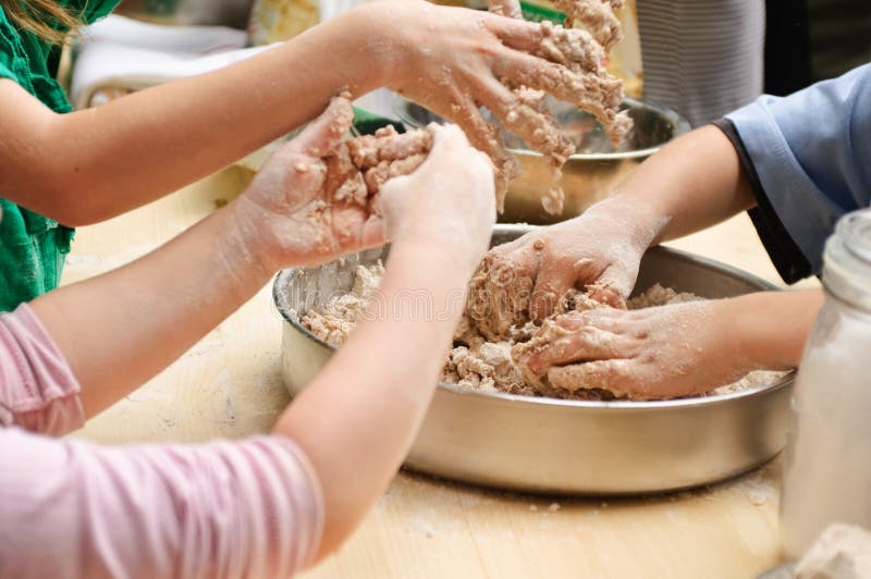 Kids hands preparing dough