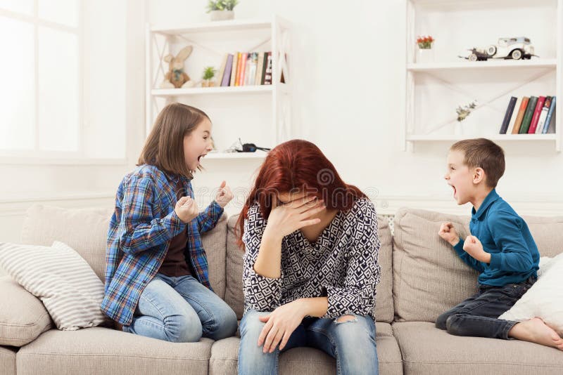Kids having quarrel over tired mother stock photos Kids having quarrel over tired mother stock photos