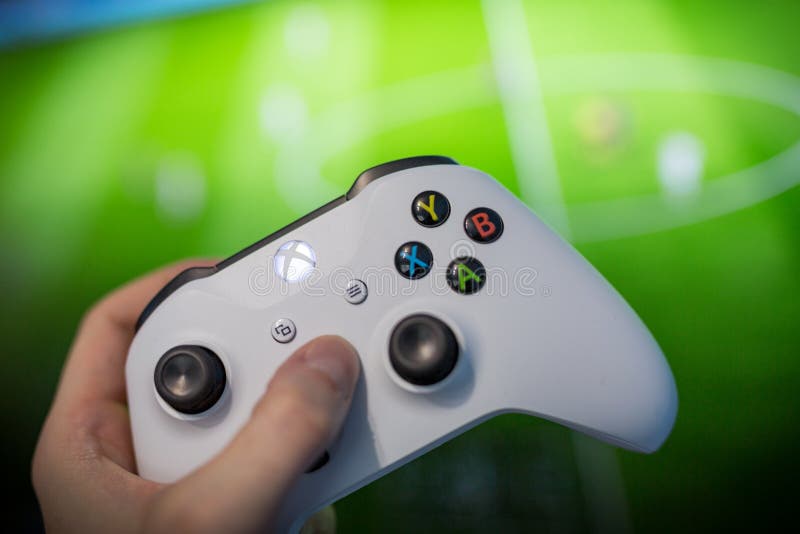 man with a controller standing in front of a PC console TV screen with a  steam controller playing popular free to play game Roblox Stock Photo -  Alamy