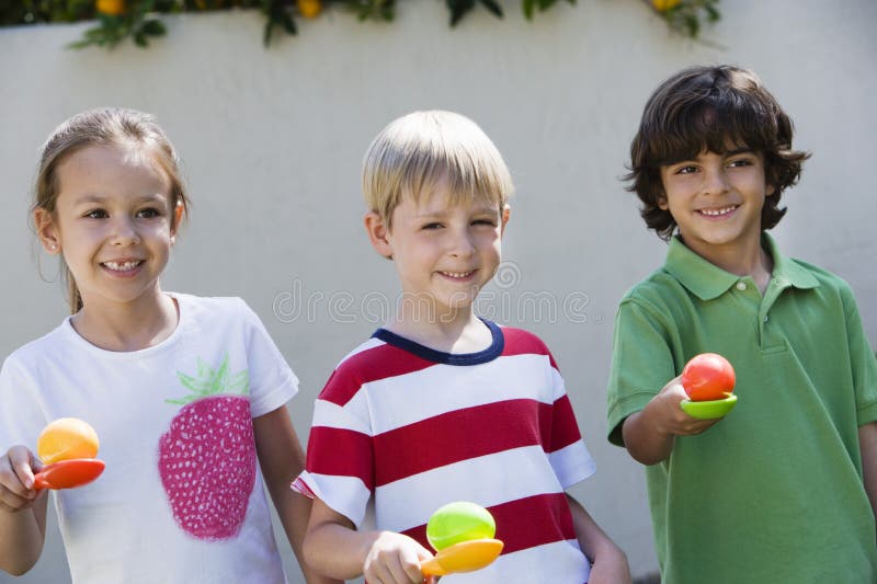 Kids Holding Eggs In Spoons For Egg Race royalty free stock image
