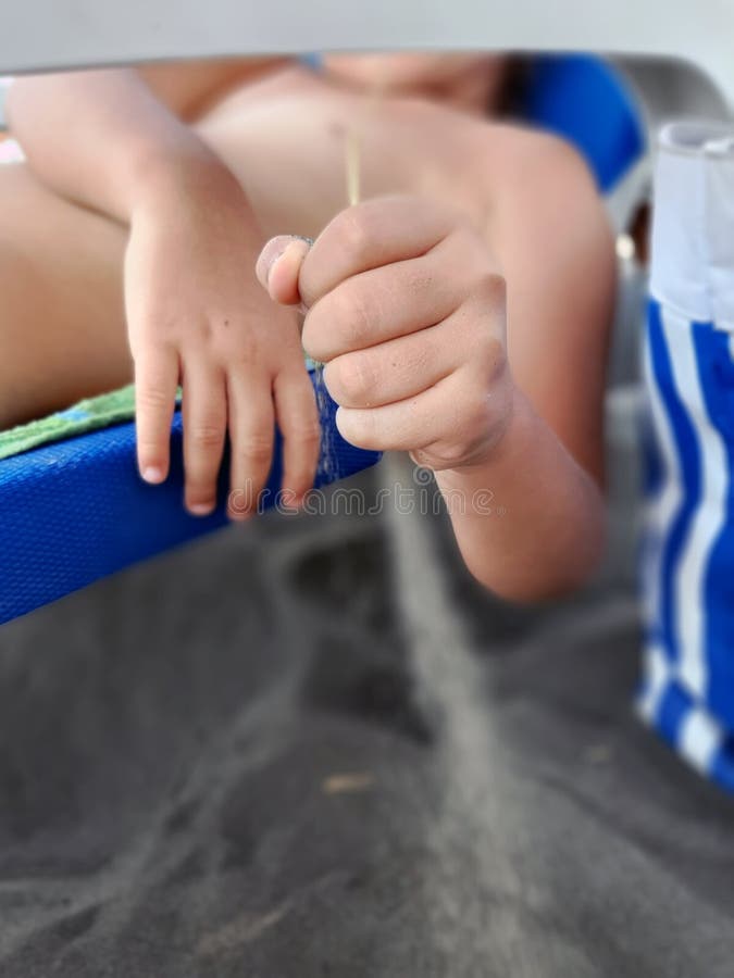 Kids Holding Sand in Its Hand. Child on the Beach Holding Sand Stock
