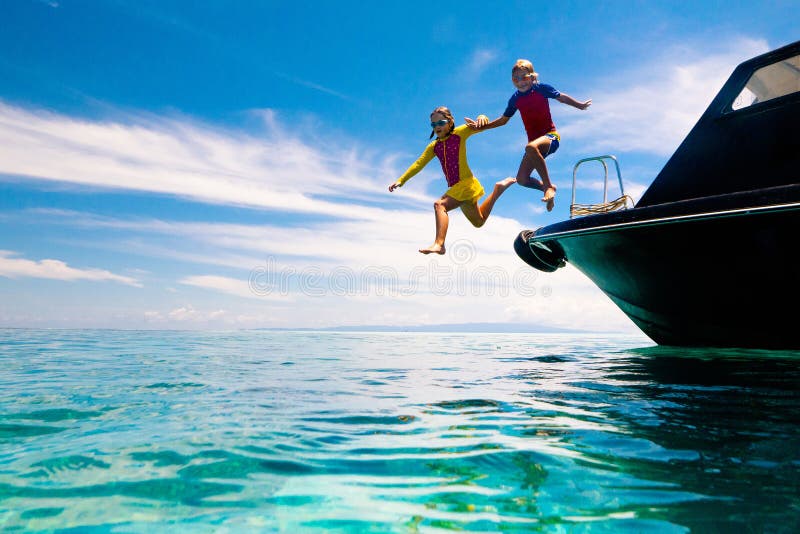 Child jumping into sea water. Yacht vacation