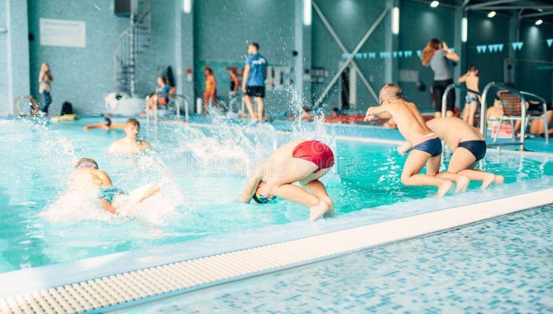 Kids jumping into pool with clean blue water stock images Kids jumping into pool with clean blue water stock images