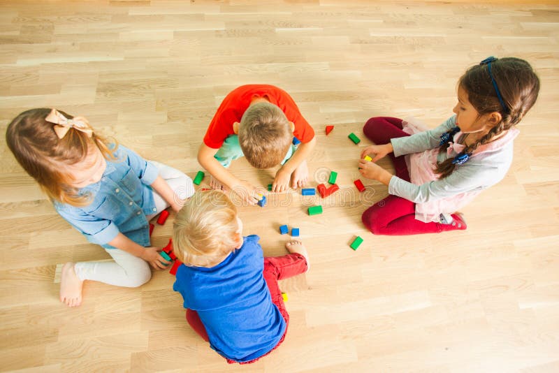 Kids in kindergarten building from wooden bricks stock images Kids in kindergarten building from wooden bricks stock images