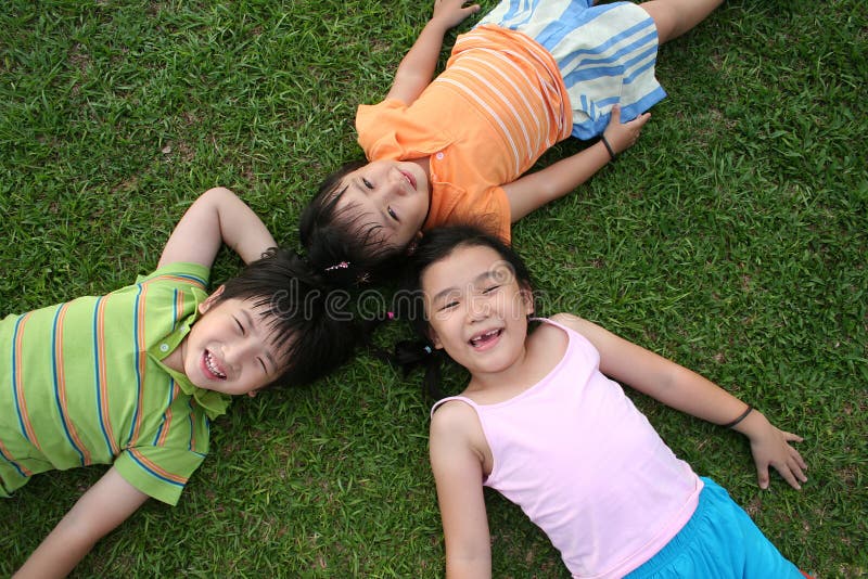 Kids lying on the grass