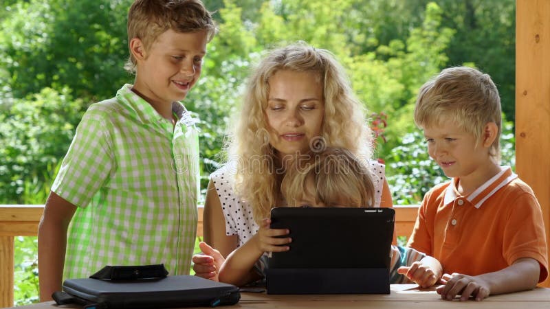 Kids and mother video chats with tablet pc