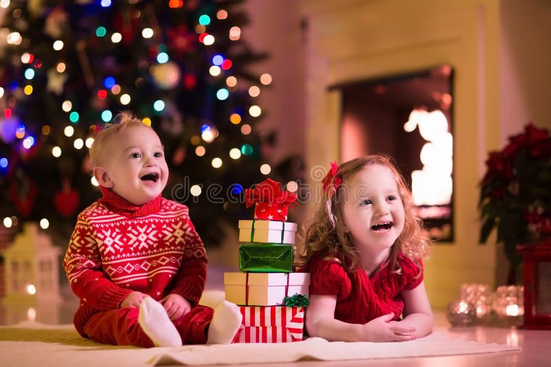 Kids Opening Christmas Presents at Fireplace Stock Photo  Image of