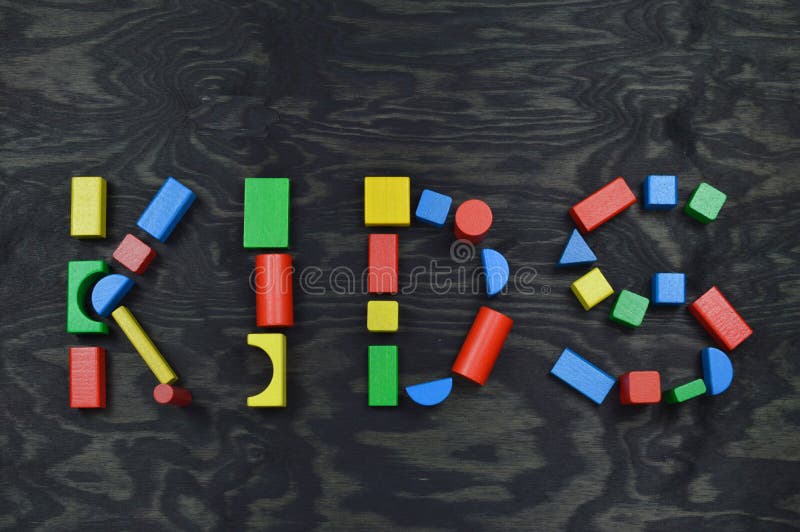 KIDS out of colorful wooden toy blocks on black royalty free stock photos