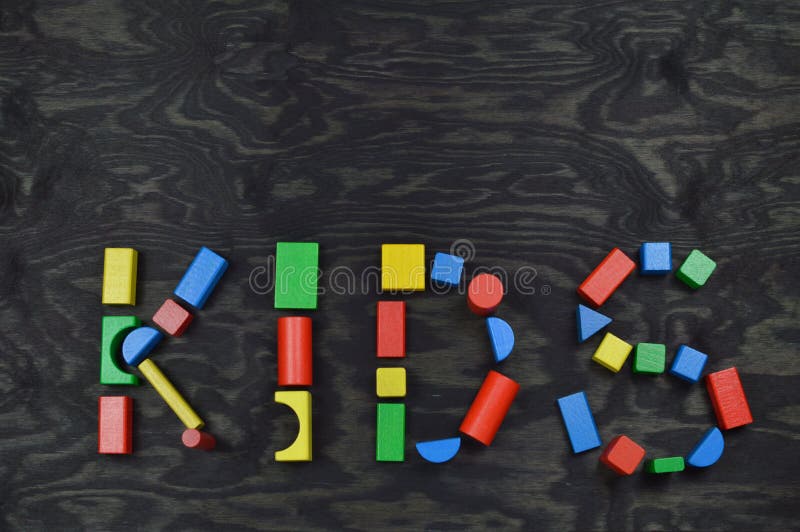 KIDS out of colorful wooden toy blocks on black royalty free stock photo