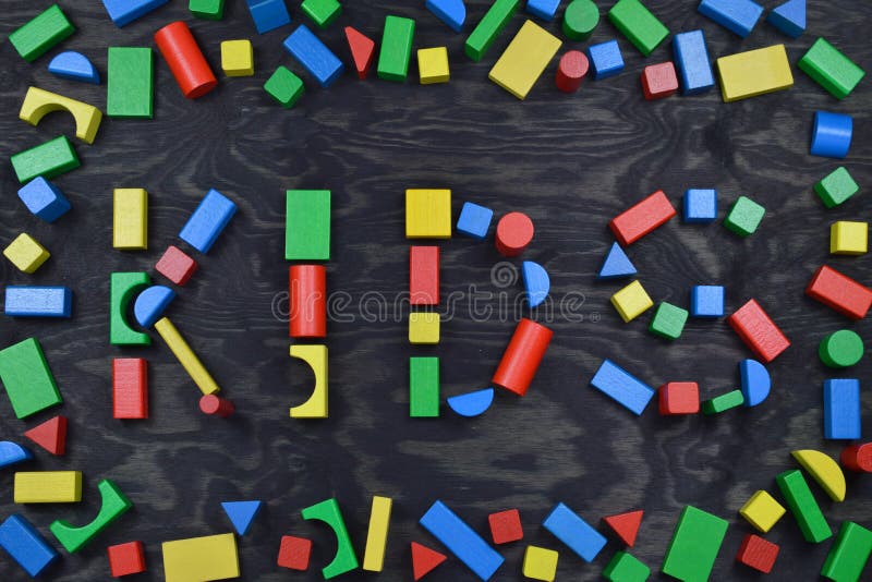 KIDS out of colorful wooden toy blocks on black royalty free stock images