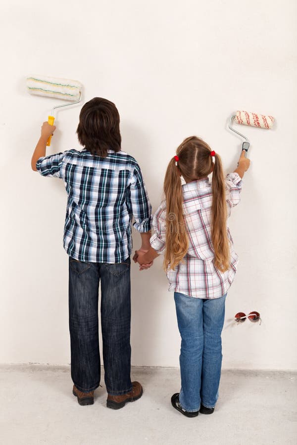 Kids painting their room together - using roller brushes