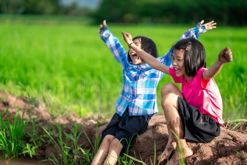 Kids planting and playing in organic rice field