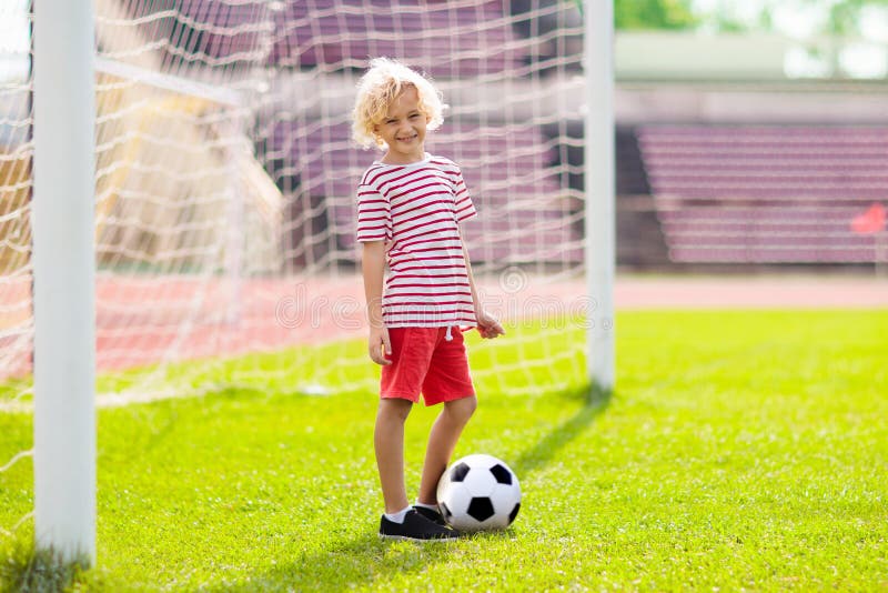 Kids play football. Child at soccer field royalty free stock photography Kids play football. Child at soccer field royalty free stock photography