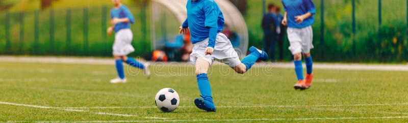 Kids Play Soccer Game. Children Outdoor Football Tournament Match on Grass Field stock images Kids Play Soccer Game. Children Outdoor Football Tournament Match on Grass Field stock images