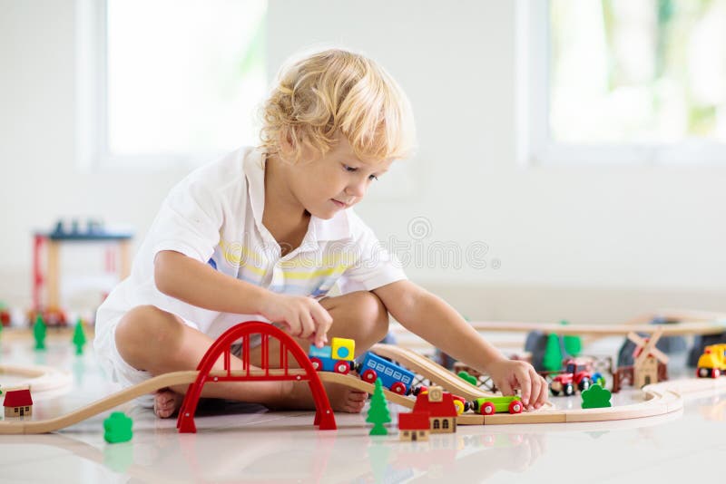 Kids play wooden railway. Child with toy train royalty free stock photography Kids play wooden railway. Child with toy train royalty free stock photography
