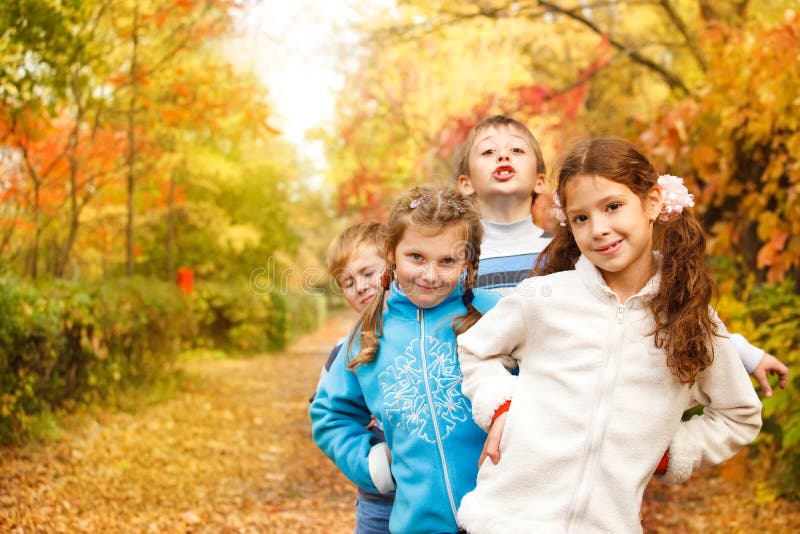 Kids playing in an autumn park royalty free stock images