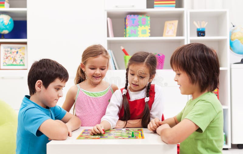 Four kids playing board game in their room