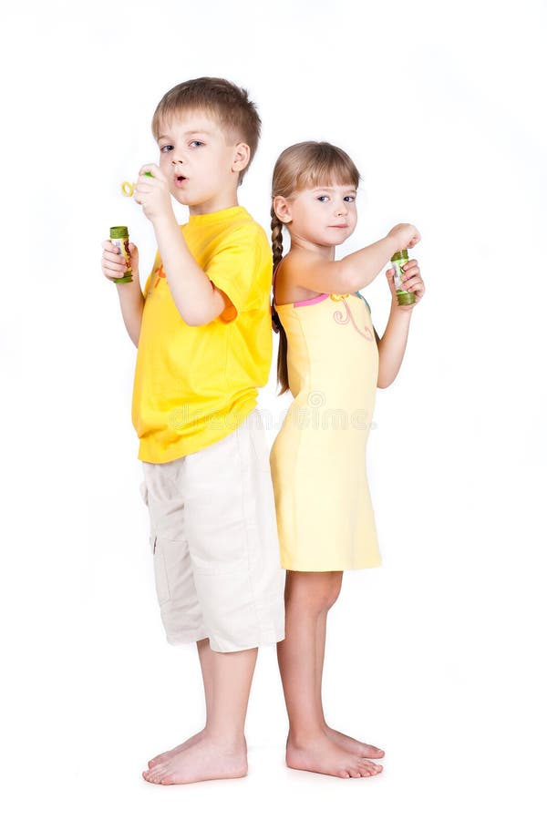 Kids playing with bubbles isolated on white