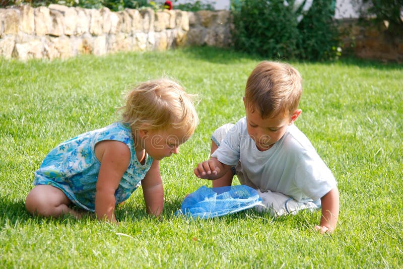 Kids playing on green grass