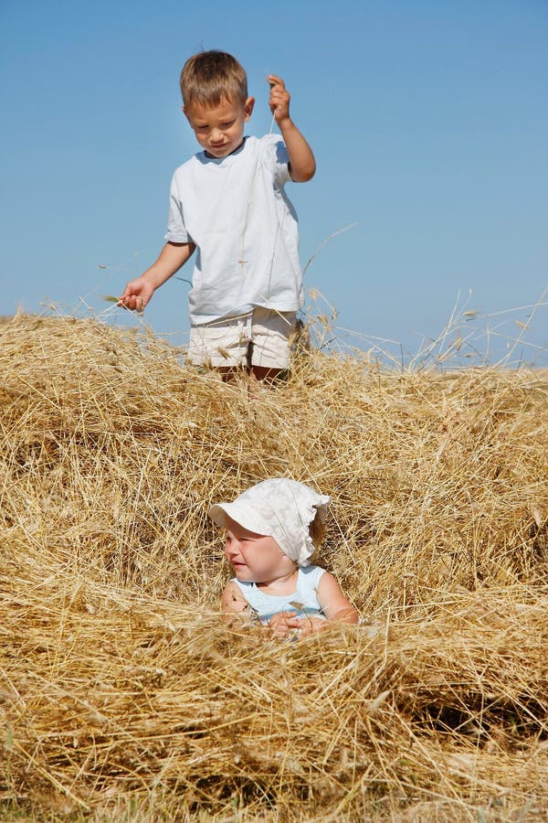 Kids playing in haystack
