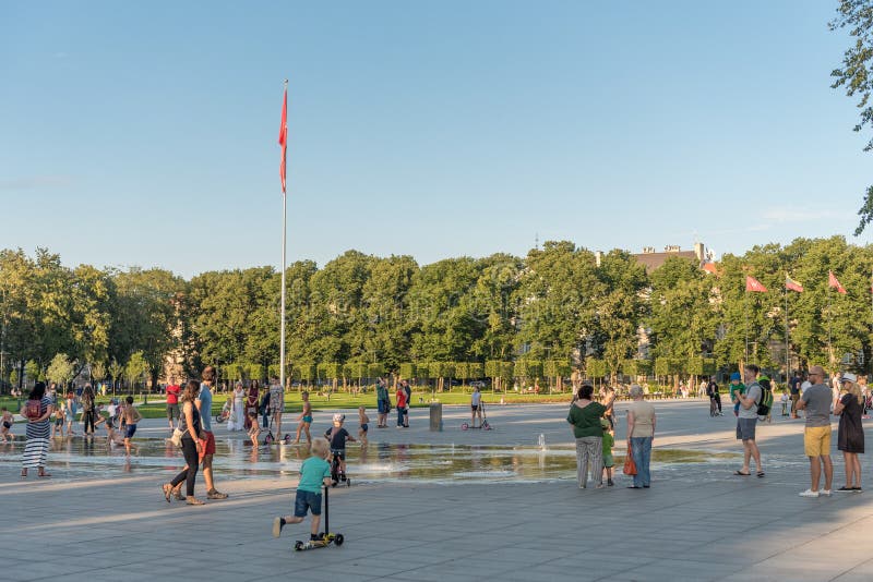 VILNIUS, LITUANIA - JULY 27, 2018: Kids Are Playing in Lukiskies Square Vilnius with Fountain and Water. Local Attraction for Chil royalty free stock image VILNIUS, LITUANIA - JULY 27, 2018: Kids Are Playing in Lukiskies Square Vilnius with Fountain and Water. Local Attraction for Chil royalty free stock image