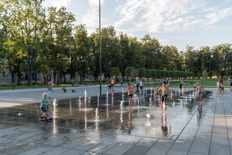 VILNIUS, LITUANIA - JULY 27, 2018: Kids Are Playing in Lukiskies Square Vilnius with Fountain and Water. Local Attraction for Chil royalty free stock photo VILNIUS, LITUANIA - JULY 27, 2018: Kids Are Playing in Lukiskies Square Vilnius with Fountain and Water. Local Attraction for Chil royalty free stock photo