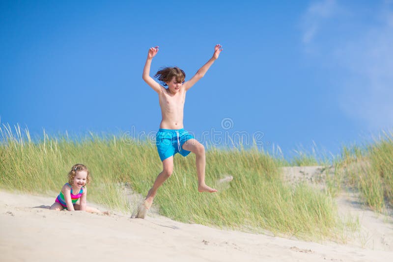 Kids playing in sand dunes