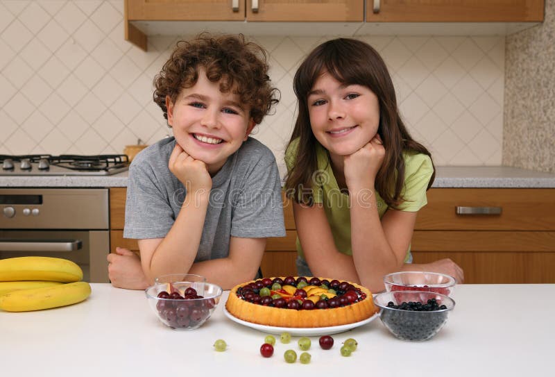 Kids preparing fruity cake