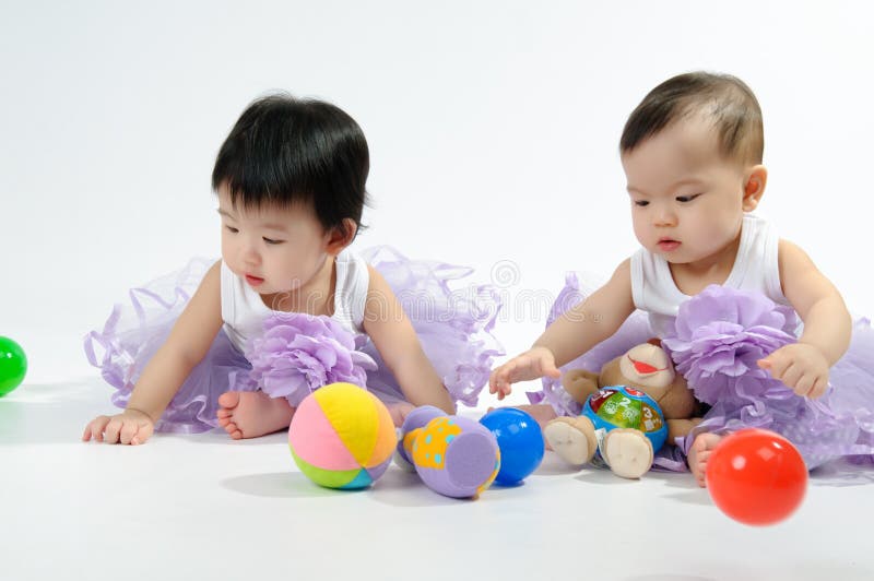 Kids in purple dress playing toy