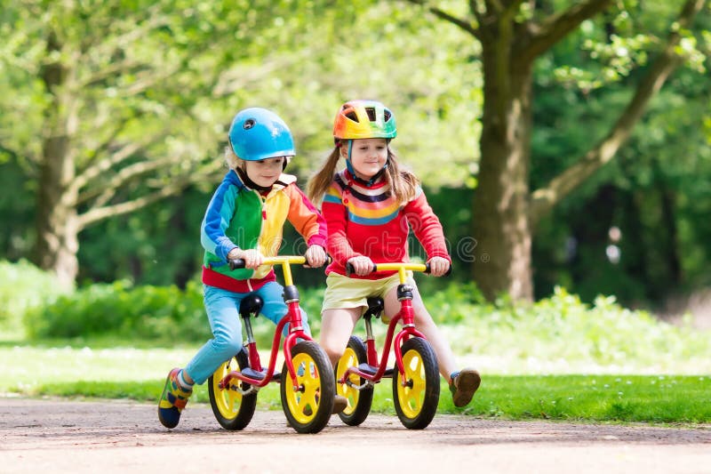 Kids ride balance bike in park. Baby, healthy.